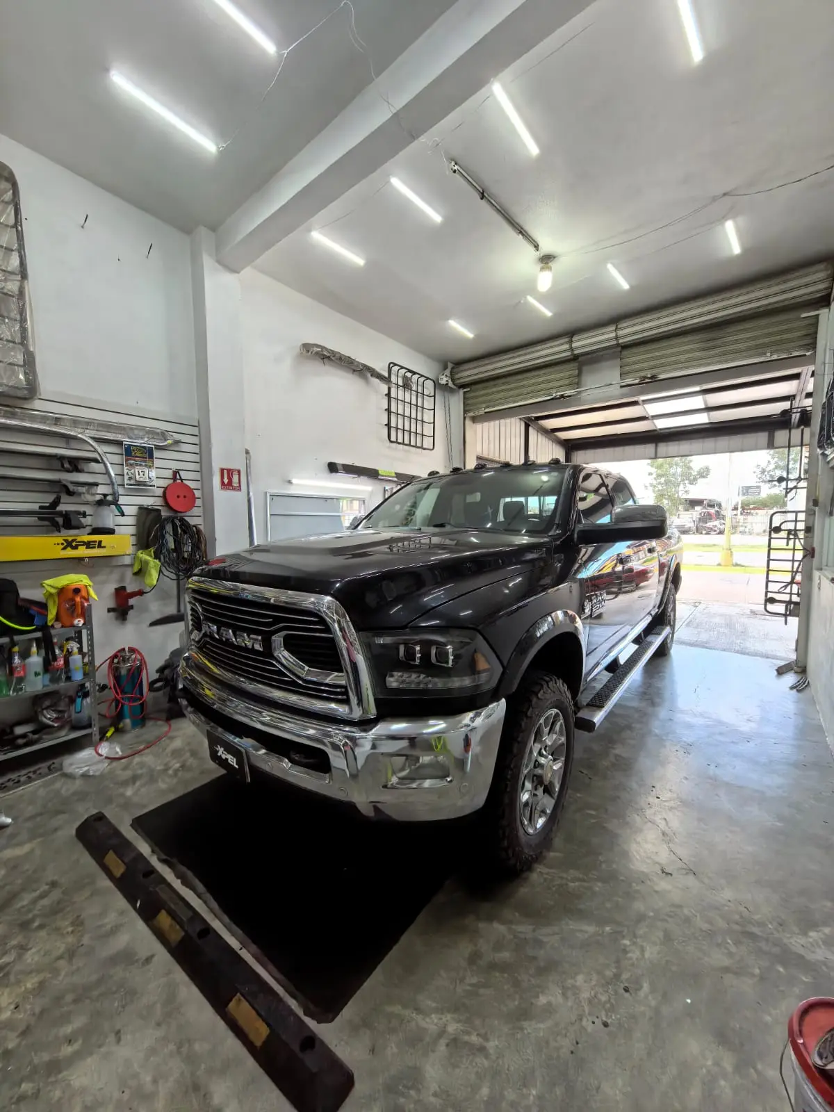 Camioneta Ram 2500 negra de frente en el taller